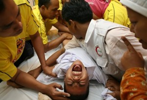 Indonesian boy being cut in Jakarta...notice the mother
